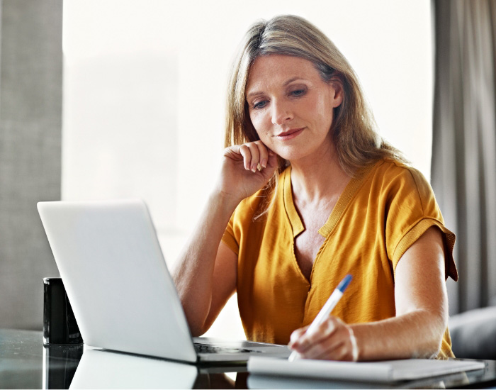 couple looking at laptop and smiling for some reason